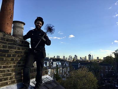 Chimney sweep on rooftops